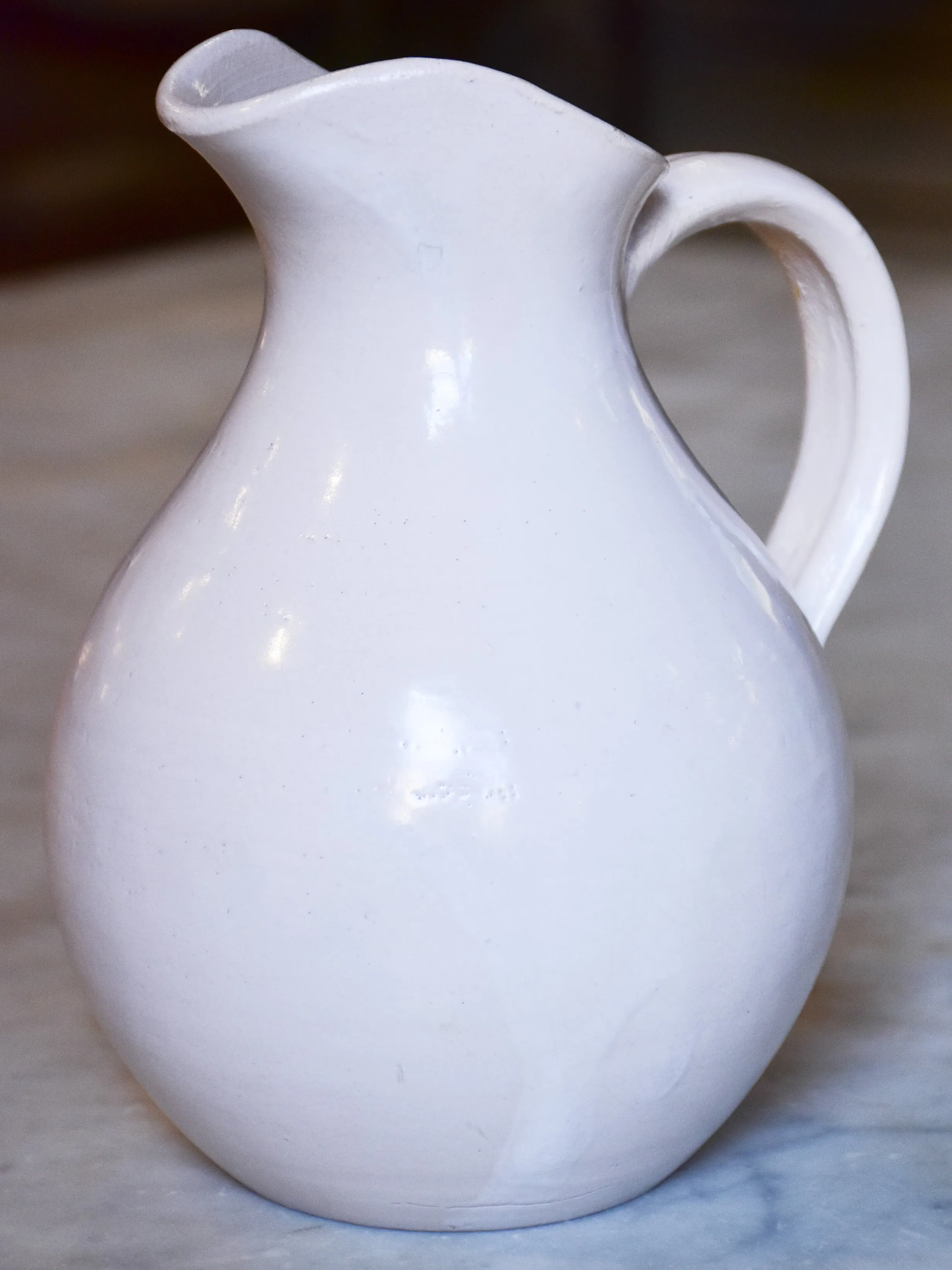 Antique French terracotta pitcher with white glaze