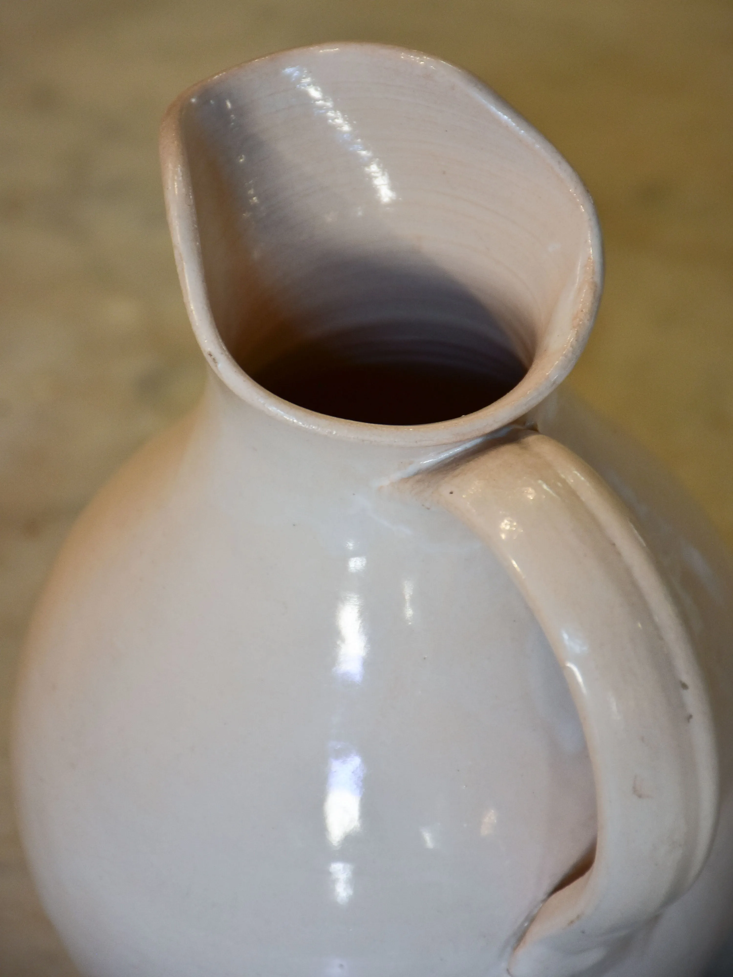 Antique French terracotta pitcher with white glaze